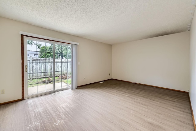 455 107th Ln NW, Coon Rapids, MN 55448 - empty room featuring light wood-style flooring and a textured ceiling