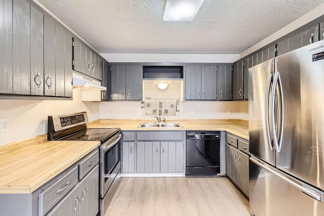 455 107th Ln NW, Coon Rapids, MN 55448 - kitchen with stainless steel appliances, under cabinet range hood, a textured ceiling, open shelves, and light wood finished floors