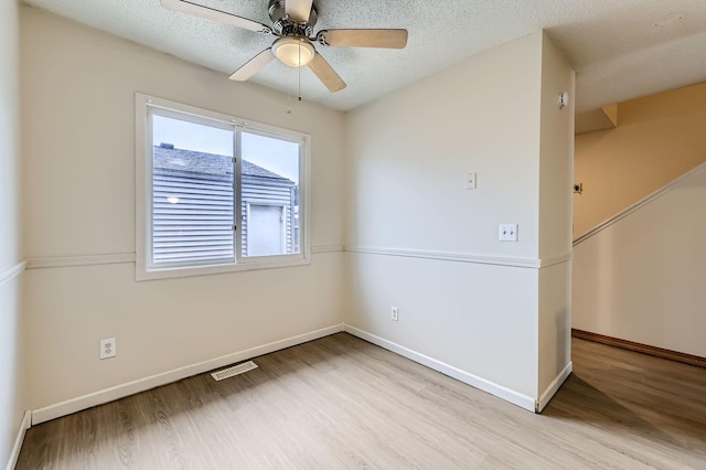 455 107th Ln NW, Coon Rapids, MN 55448 - spare room featuring wood finished floors, ceiling fan, and a textured ceiling