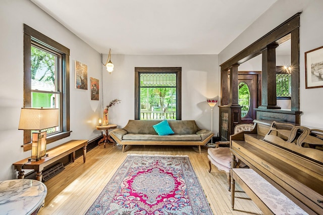 3231 41st Ave S, Minneapolis, MN 55406 - living room featuring healthy amount of natural light, hardwood / wood-style flooring, and decorative columns