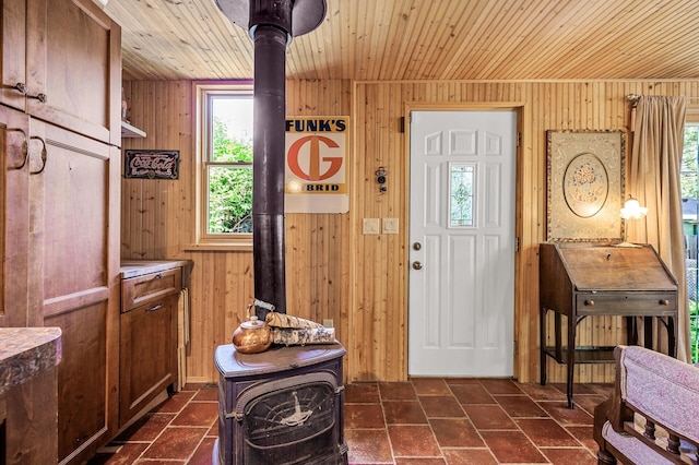 3231 41st Ave S, Minneapolis, MN 55406 - entrance foyer featuring a wood stove, wooden ceiling, and wooden walls
