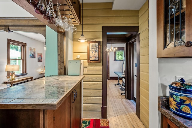 3231 41st Ave S, Minneapolis, MN 55406 - bar area featuring wood walls, light wood-style flooring, and a chandelier