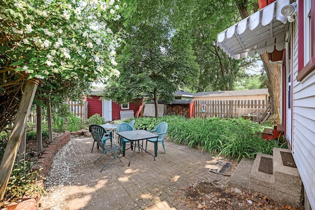 3231 41st Ave S, Minneapolis, MN 55406 - view of patio / terrace featuring outdoor dining space and an outdoor structure