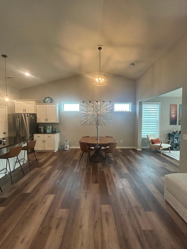 8756 151st Ave NW, Ramsey, MN 55303 - dining room featuring dark wood-style flooring, vaulted ceiling, and plenty of natural light