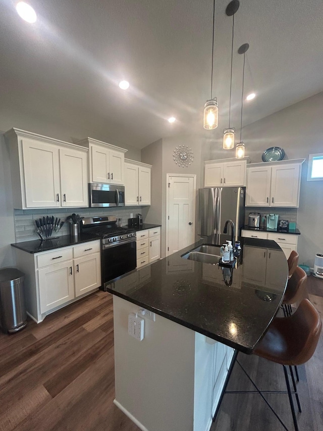 8756 151st Ave NW, Ramsey, MN 55303 - kitchen with appliances with stainless steel finishes, backsplash, dark countertops, dark wood-style flooring, and white cabinets
