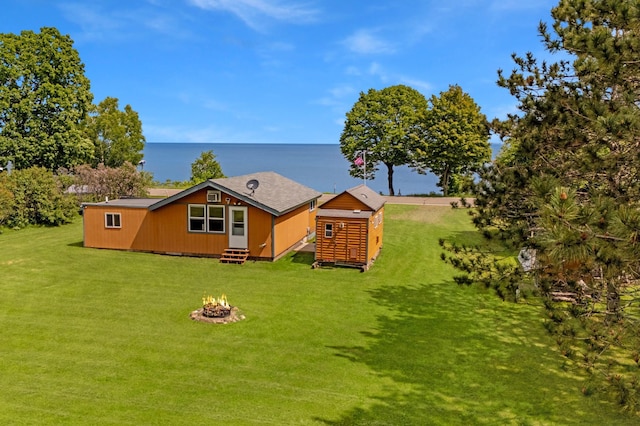 12833 Twilight Rd, South Harbor Twp, MN 56359 - back of house with an outdoor fire pit, a yard, a storage shed, entry steps, and a water view