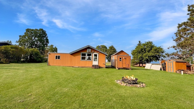 12833 Twilight Rd, South Harbor Twp, MN 56359 - rear view of property with a shed, a fire pit, a yard, and entry steps