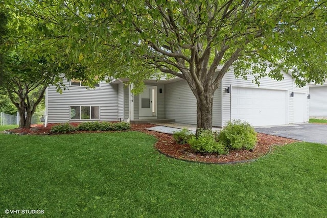 9019 Idaho Ave N, Brooklyn Park, MN 55445 - obstructed view of property with driveway, a front lawn, and an attached garage