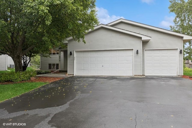 9019 Idaho Ave N, Brooklyn Park, MN 55445 - view of front of house featuring driveway and a garage