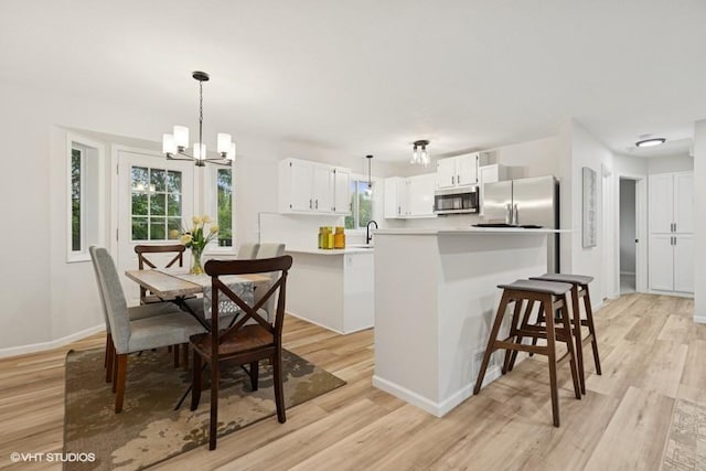 9019 Idaho Ave N, Brooklyn Park, MN 55445 - dining space featuring a chandelier and light wood-style flooring