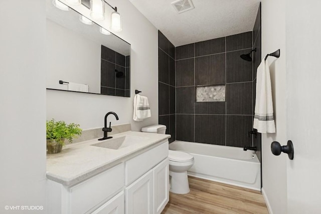 9019 Idaho Ave N, Brooklyn Park, MN 55445 - bathroom featuring vanity, wood finished floors, and bathing tub / shower combination