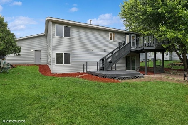 9019 Idaho Ave N, Brooklyn Park, MN 55445 - back of house featuring a wooden deck, stairs, and a lawn