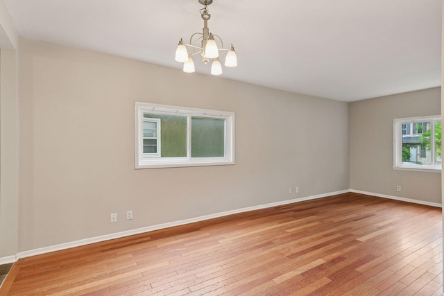 724 Pierce St NE, Minneapolis, MN 55413 - spare room featuring a chandelier and light wood-style floors