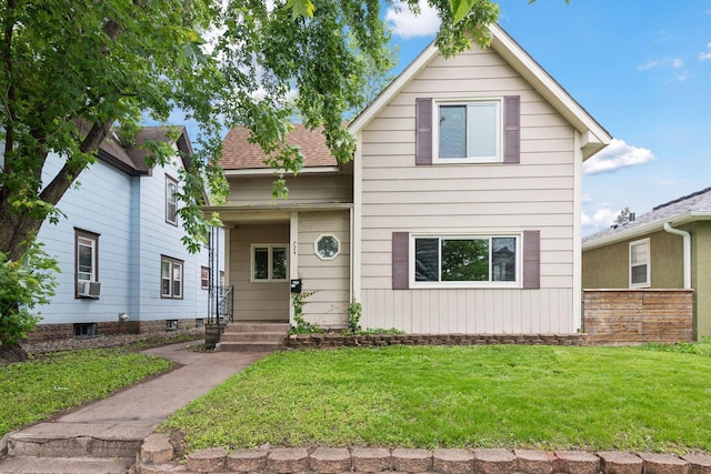 724 Pierce St NE, Minneapolis, MN 55413 - view of front facade featuring a front lawn and cooling unit