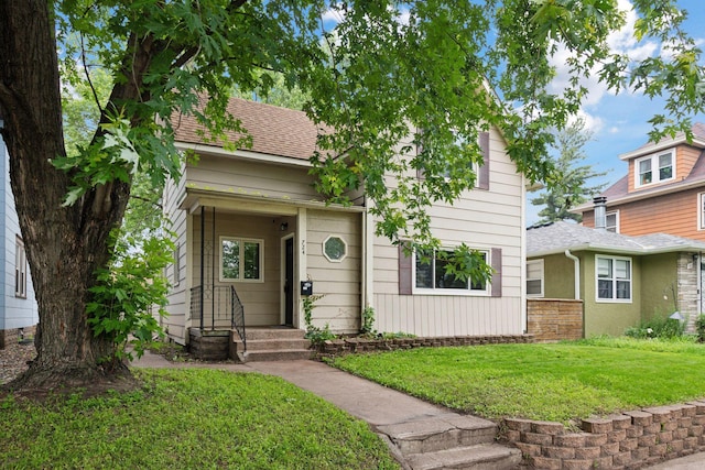 724 Pierce St NE, Minneapolis, MN 55413 - view of front of home with a front lawn and a shingled roof