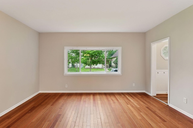724 Pierce St NE, Minneapolis, MN 55413 - unfurnished room with wood-type flooring and baseboards