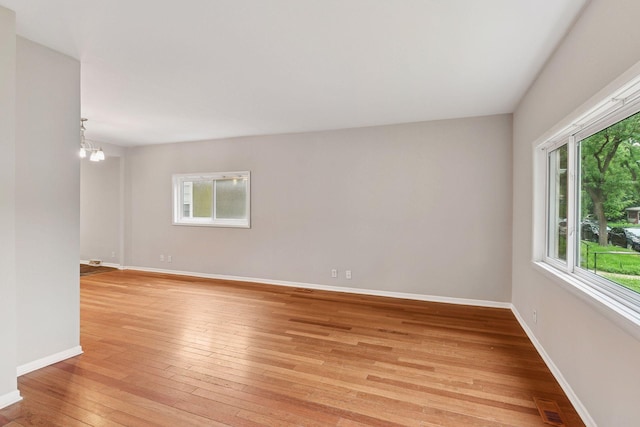724 Pierce St NE, Minneapolis, MN 55413 - unfurnished room with light wood-style flooring and a chandelier