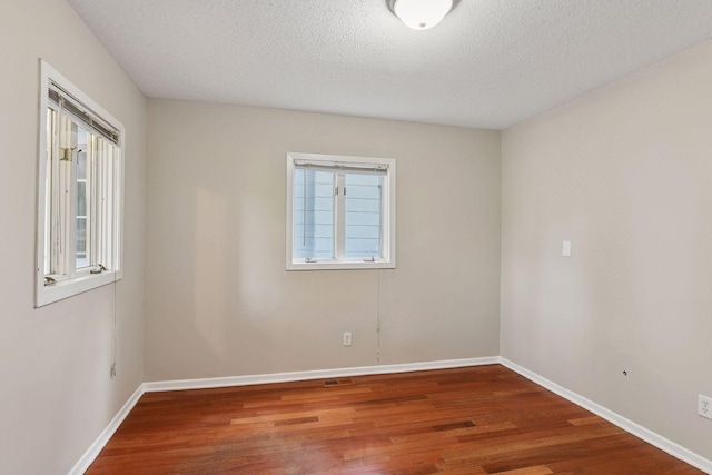 724 Pierce St NE, Minneapolis, MN 55413 - empty room with wood finished floors and a textured ceiling