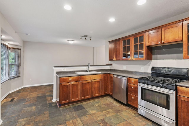 724 Pierce St NE, Minneapolis, MN 55413 - kitchen with stainless steel appliances, a peninsula, dark stone finish flooring, dark countertops, and recessed lighting