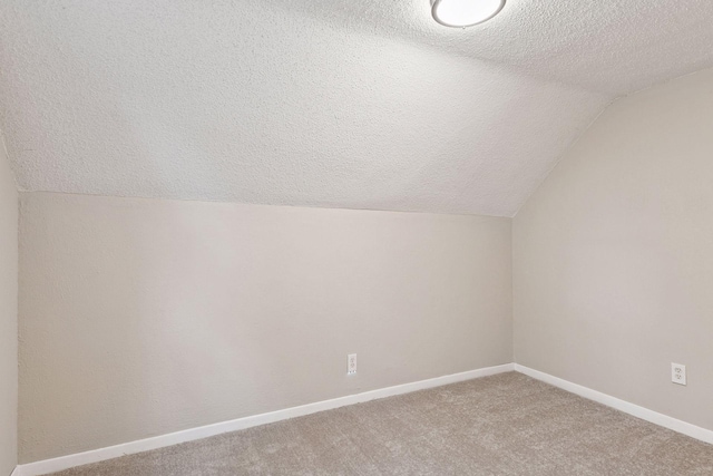 724 Pierce St NE, Minneapolis, MN 55413 - bonus room featuring lofted ceiling, a textured ceiling, and carpet flooring
