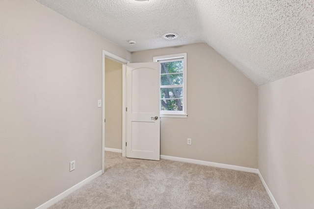 724 Pierce St NE, Minneapolis, MN 55413 - additional living space with a textured ceiling, vaulted ceiling, and carpet floors