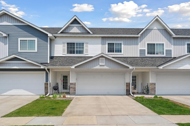 8468 Gateway Cir, Monticello, MN 55362 - view of property with a shingled roof, stone siding, and board and batten siding