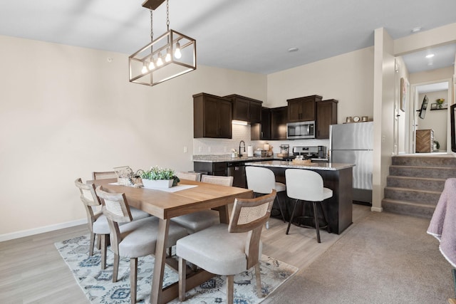 8468 Gateway Cir, Monticello, MN 55362 - dining space with light wood-style flooring, stairway, and recessed lighting