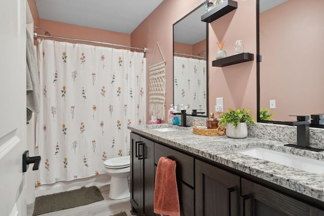 8468 Gateway Cir, Monticello, MN 55362 - full bathroom featuring double vanity, wood finished floors, and curtained shower