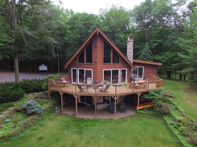 28716 Kilkare Rd, Danbury, WI 54830 - rear view of property featuring a patio area, a wooden deck, a yard, and a chimney