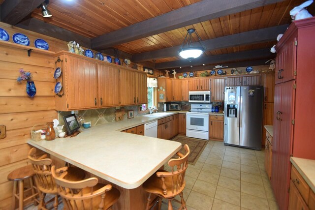 28716 Kilkare Rd, Danbury, WI 54830 - kitchen featuring white appliances, a peninsula, light countertops, a wooden ceiling with exposed beams, and light tile patterned floors