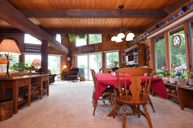 28716 Kilkare Rd, Danbury, WI 54830 - carpeted dining space with a wood ceiling with exposed beams, a chandelier, and wooden walls
