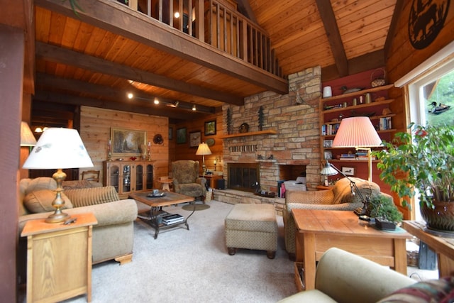 28716 Kilkare Rd, Danbury, WI 54830 - living room featuring a wood ceiling with exposed beams, carpet flooring, wood walls, and a fireplace