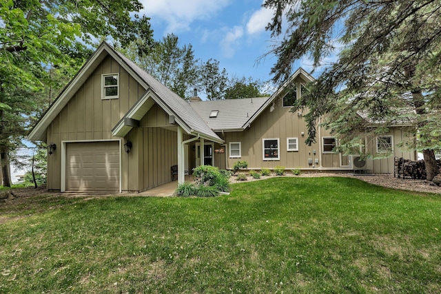 13188 Chicago Club Ln NE, Alexandria, MN 56308 - rear view of house featuring board and batten siding, a lawn, and a garage