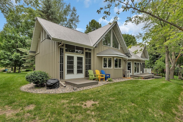 13188 Chicago Club Ln NE, Alexandria, MN 56308 - rear view of house with french doors, a wooden deck, and a lawn