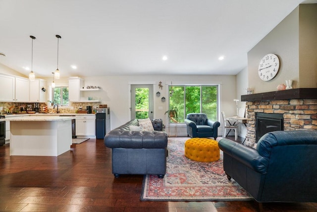 1115 Timber Path, Menomonie, WI 54751 - living area with dark wood-style floors, vaulted ceiling, a fireplace, and recessed lighting