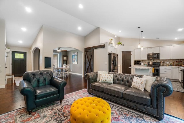 1115 Timber Path, Menomonie, WI 54751 - living room with vaulted ceiling, wood finished floors, a barn door, arched walkways, and a ceiling fan