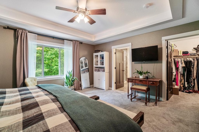 1115 Timber Path, Menomonie, WI 54751 - bedroom featuring a raised ceiling, a spacious closet, light colored carpet, a closet, and ceiling fan