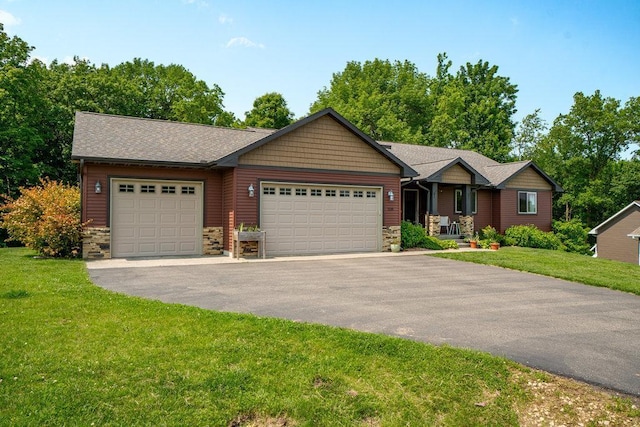 1115 Timber Path, Menomonie, WI 54751 - view of front of property featuring stone siding, driveway, a garage, and a front lawn
