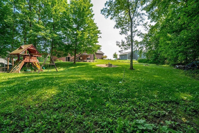 1115 Timber Path, Menomonie, WI 54751 - view of green lawn featuring a playground and a fire pit