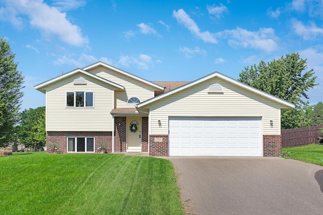 205 4th St NW, Saint Michael, MN 55376 - tri-level home with brick siding, asphalt driveway, and an attached garage