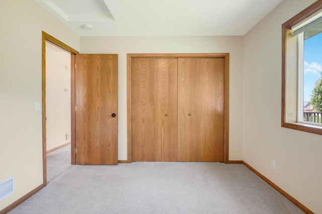 205 4th St NW, Saint Michael, MN 55376 - unfurnished bedroom featuring carpet floors, multiple windows, and a closet