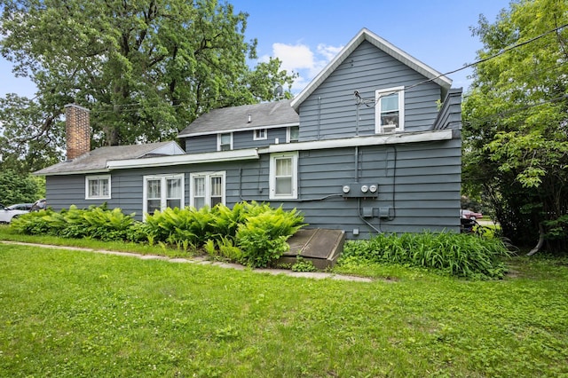 321 6th Ave E, Alexandria, MN 56308 - rear view of property with a chimney and a lawn