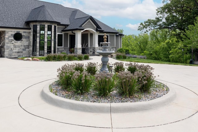 1500 Weatherhill Ridge Ct SW, Rochester Twp, MN 55902 - view of front of house with stone siding, curved driveway, and a shingled roof