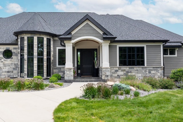 1500 Weatherhill Ridge Ct SW, Rochester Twp, MN 55902 - view of front of house with stone siding, a shingled roof, and a front yard