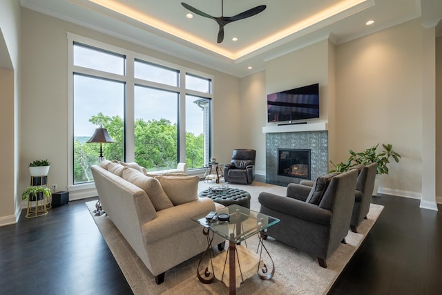 1500 Weatherhill Ridge Ct SW, Rochester Twp, MN 55902 - living room with a tiled fireplace, a ceiling fan, a tray ceiling, wood finished floors, and recessed lighting