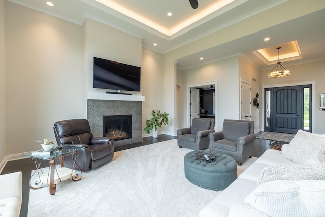 1500 Weatherhill Ridge Ct SW, Rochester Twp, MN 55902 - living area with a raised ceiling, ornamental molding, recessed lighting, and a tile fireplace