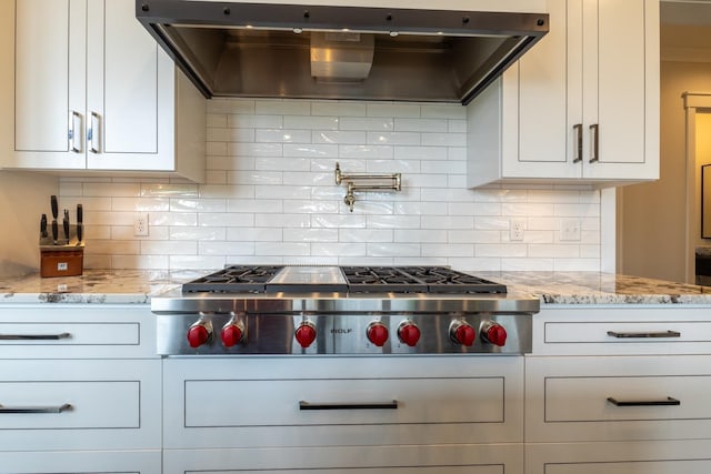 1500 Weatherhill Ridge Ct SW, Rochester Twp, MN 55902 - kitchen with extractor fan, stainless steel gas cooktop, light stone counters, and white cabinetry