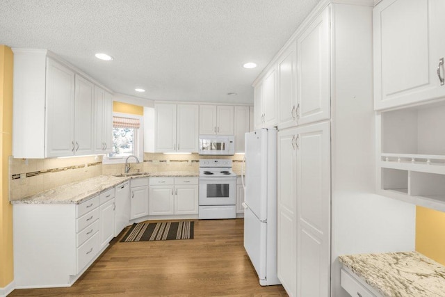 8425 Rice Lake Rd, Maple Grove, MN 55369 - kitchen featuring white appliances, white cabinets, wood finished floors, recessed lighting, and decorative backsplash