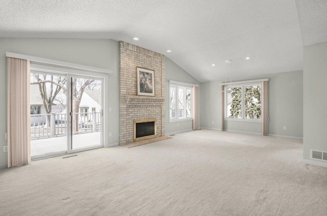 8425 Rice Lake Rd, Maple Grove, MN 55369 - unfurnished living room featuring a textured ceiling, vaulted ceiling, carpet flooring, recessed lighting, and a fireplace