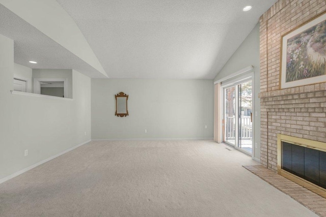 8425 Rice Lake Rd, Maple Grove, MN 55369 - unfurnished living room with vaulted ceiling, carpet flooring, a textured ceiling, a brick fireplace, and recessed lighting